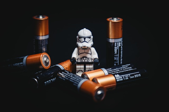 An image of a Star Wars stormtrooper toy surrounded by AA batteries.