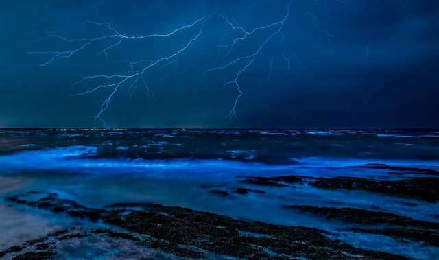 Lightning is caused by a high voltage between the ground and bottom of a cloud.