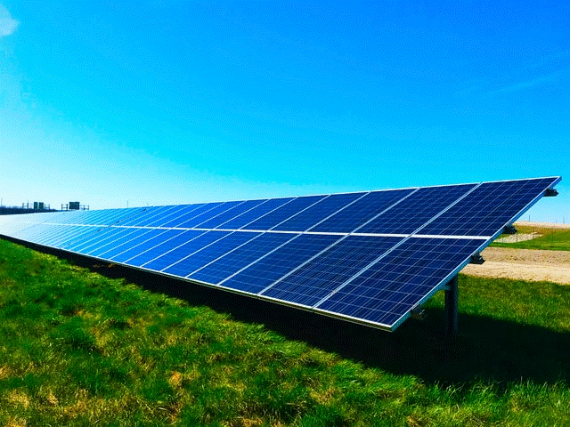 Solar panels on a field of grass.