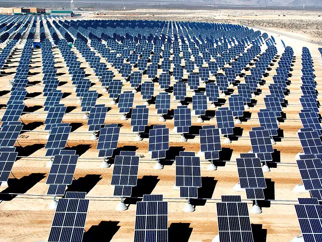 An array of solar panels in the desert.